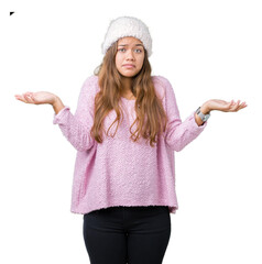 Young beautiful brunette woman wearing sweater and winter hat over isolated background clueless and...