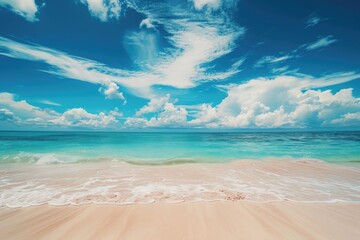 A beautiful sandy beach with a clear blue sky and fluffy white clouds. Perfect for summer vacation or travel-related designs