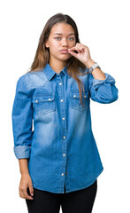 Young beautiful brunette woman wearing blue denim shirt over isolated background mouth and lips...