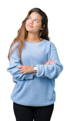 Young beautiful brunette woman wearing blue winter sweater over isolated background smiling looking...