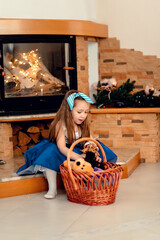 Little girl by the fireplace waiting for Christmas