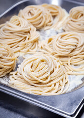 Close up of Italian pasta fettuccine on a baking tray
