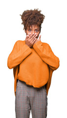 Beautiful young african american woman over isolated background shocked covering mouth with hands...
