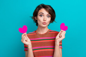 Photo of funky nice woman dressed striped t-shirt hold two paper heart postcards pouted lips isolated on turquoise color background