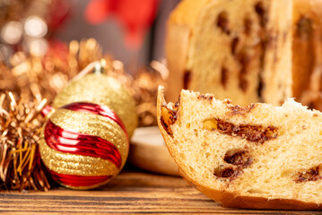 Panettone, panettone with chocolate flavors on a rustic table with Christmas decorations. Selective focus.