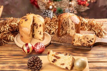 Panettone, panettone with chocolate flavors on a rustic table with Christmas decorations. Selective focus.