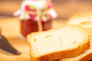 Jam and toast, jar of jam and toast on rustic wood. Selective focus.
