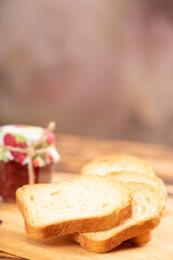 Jam and toast, jar of jam and toast on rustic wood. Selective focus.