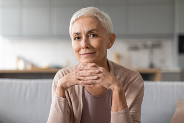 Portrait of confident european senior lady with stylish haircut indoor - Powered by Adobe