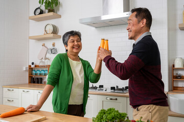 Cheerful Mature couple have spending time together in kitchen