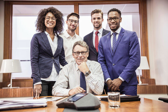 Group picture of mixed racial colleagues in conference room smiling in the camera. Cape Town, South Africa
