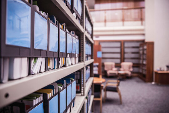 Shelves with binders and books in large start-up office space. Cape Town, South Africa