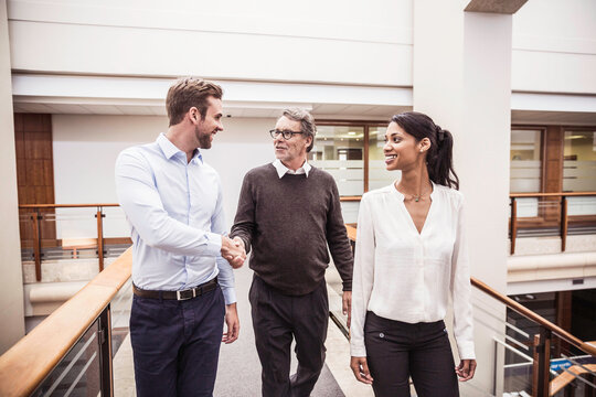 Colleagues with diverse backgrounds working, talking and hanging out in large office space. Cape Town, South Africa