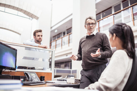 Colleagues with diverse backgrounds working, talking and hanging out in large office space. Cape Town, South Africa
