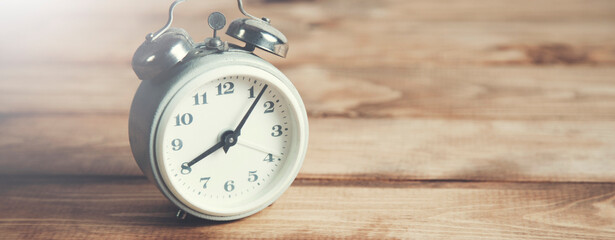 alarm clock on wooden table background