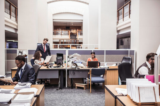 Colleagues with diverse backgrounds working, talking and hanging out in large office space. Cape Town, South Africa