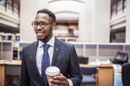 Colleagues with diverse backgrounds working, talking and hanging out in large office space. Cape Town, South Africa
