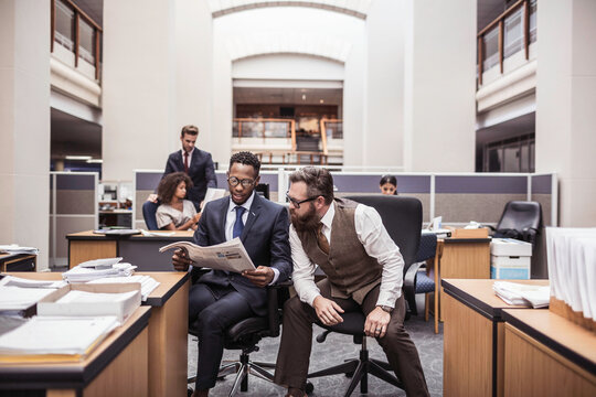 Colleagues with diverse backgrounds working, talking and hanging out in large office space. Cape Town, South Africa