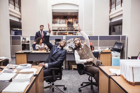 Colleagues with diverse backgrounds working, talking and hanging out in large office space. Cape Town, South Africa
