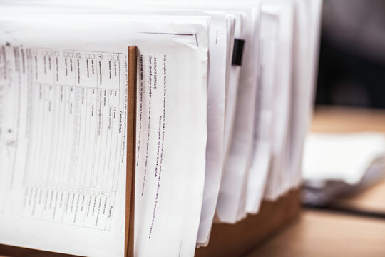 Documents in stand in large start-up office space. Cape Town, South Africa