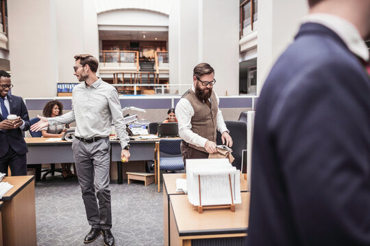 Colleagues with diverse backgrounds working, talking and hanging out in large office space. Cape Town, South Africa