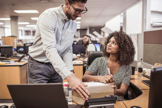 Colleagues with diverse backgrounds working, talking and hanging out in large office space. Cape Town, South Africa