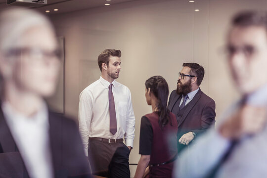 Office coworkers together in discussion in a meeting room and having a team building workshop