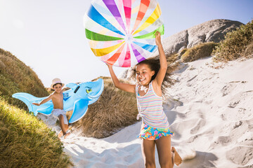 Mixed race family having fun playing on the beach. Cape Town, South Africa