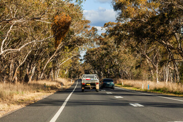 Vehicle overtaking ute on dotted lines on rural highway road