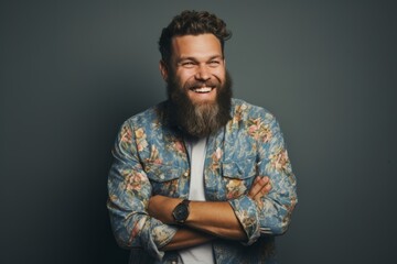 Portrait of a happy bearded man in a jacket on a dark background.