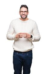 Young handsome man wearing glasses over isolated background Hands together and fingers crossed smiling relaxed and cheerful. Success and optimistic