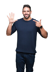 Young handsome man wearing sweater over isolated background showing and pointing up with fingers number seven while smiling confident and happy.