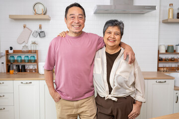 Obraz premium Cheerful Mature couple have spending time together in kitchen