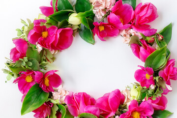 flower wreath. a woman's beautiful wreath woven from pink bright flowers lies on a white table, beauty concept