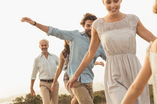family walking on a board walk at a beach house