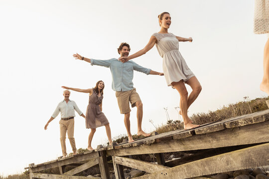 family walking on a board walk at a beach house