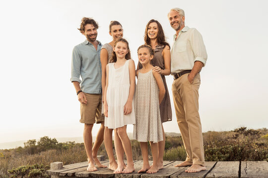 Family portrait outside on a boardwalk at a beach house