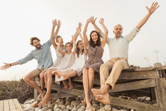 Family portrait outside on a boardwalk at a beach house