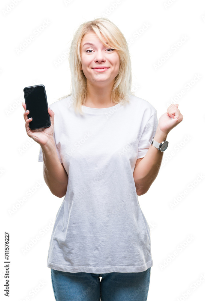 Poster young beautiful blonde woman showing screen of smartphone over isolated background screaming proud a