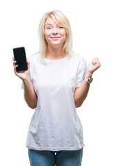 Fototapeta premium Young beautiful blonde woman showing screen of smartphone over isolated background screaming proud and celebrating victory and success very excited, cheering emotion