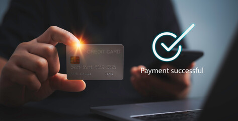 Payment successful concept.Hand holding credit card and smartphone with Payment successful.Online Money Transfer Confirmed.Concept of e-commerce and online banking, payment transfer. - obrazy, fototapety, plakaty