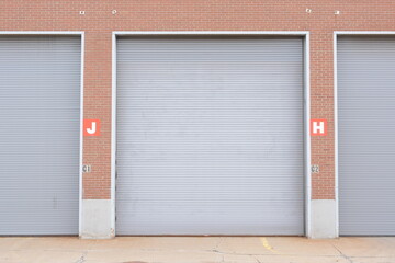 Fototapeta na wymiar Large industrial loading dock doors on brick warehouse
