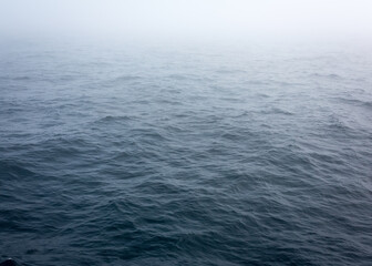 Russia Sakhalin Oblast 27.07.2023 Sea of Okhotsk in the fog. The line of the horizon, dissolving in the fog. Space for text. Marine texture