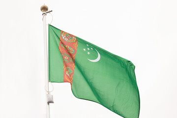 State flag of Turkmenistan. A large State flag of Turkmenistan flutters in the wind. Close-up. Great for news. National flag of Turkmenistan on a white background