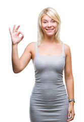 Fototapeta premium Young beautiful blonde woman over isolated background smiling positive doing ok sign with hand and fingers. Successful expression.