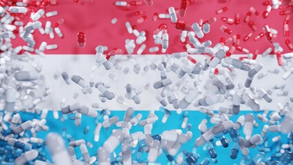 Capsule pills fall on a flag of Luxembourg. The Pharmaceutical Industry in Luxembourg - Medicine healthcare medicaments. 3d render