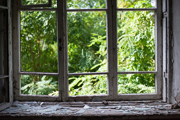 open window with old wooden frame. old window. finely broken glass. old house, retro. cracked window frame. cracked old paint, pieces of glass. space for text. large pieces of glass. horror
