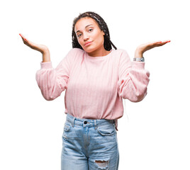 Young braided hair african american girl wearing sweater over isolated background clueless and...