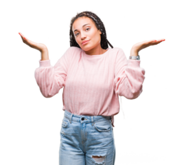Young braided hair african american girl wearing sweater over isolated background clueless and confused expression with arms and hands raised. Doubt concept.