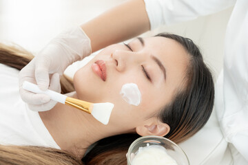 Beautiful woman receive spa and treatment skin of face. face of a healthy woman apply cream....